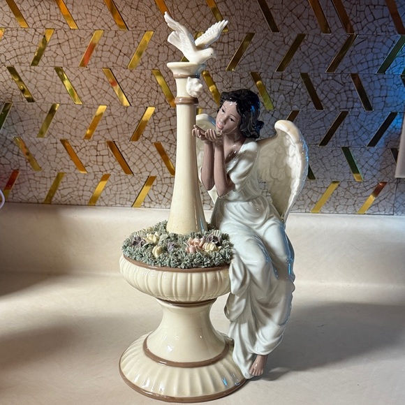 Grandeur Noel porcelain angel sculpture in a fountain